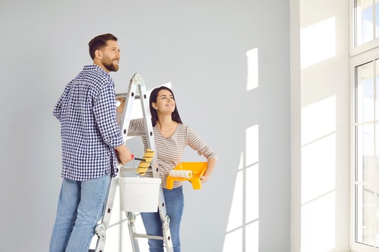 Smiling,Married,Young,Couple,Doing,Renovations,At,Home